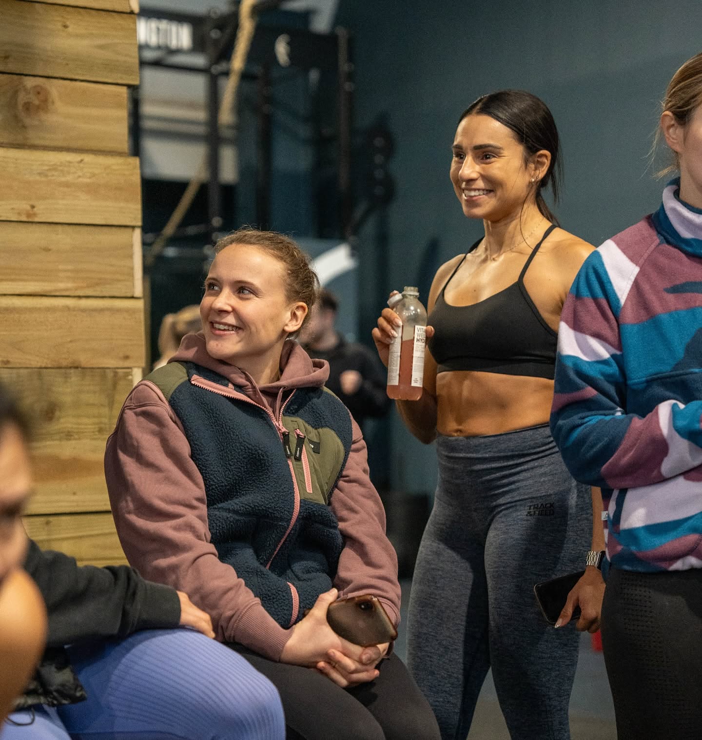 Two members sharing a laugh during the class briefing